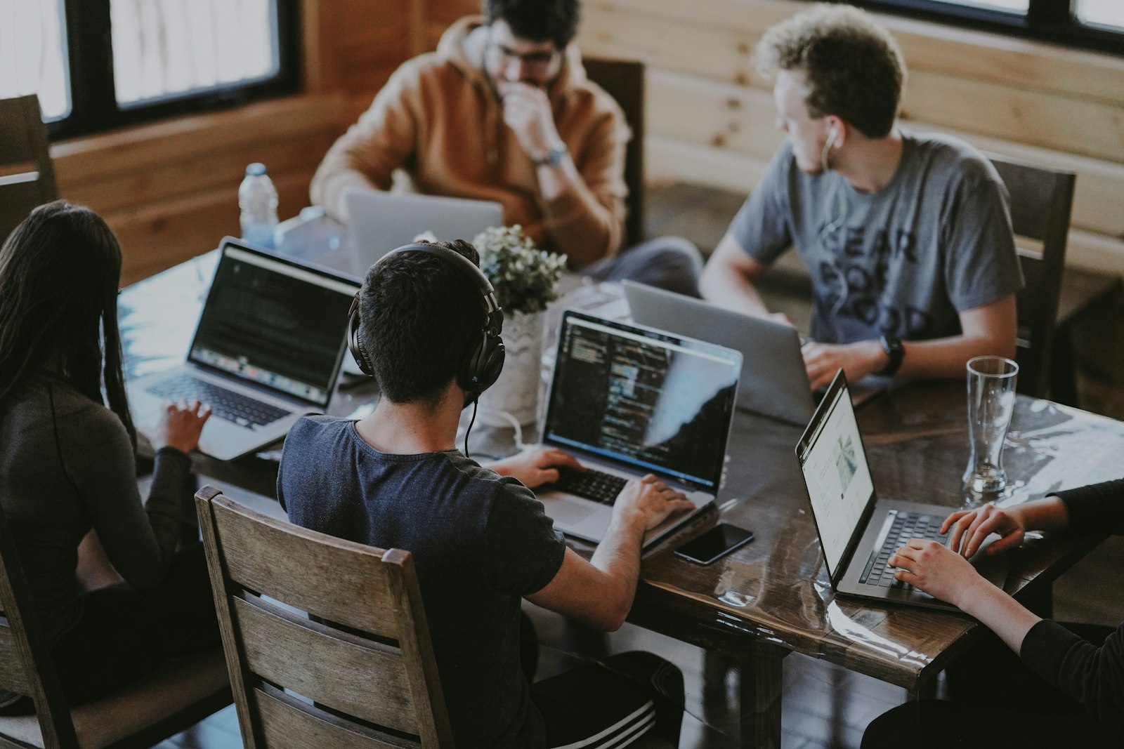 A team working together around laptops